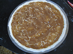 Pan of cooked onions for steak pizza