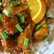 Orange chicken with green onions served over white rice