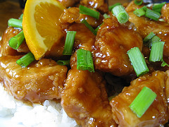 Orange chicken with green onions served over white rice