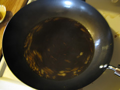 Orange sauce cooking in a black skillet