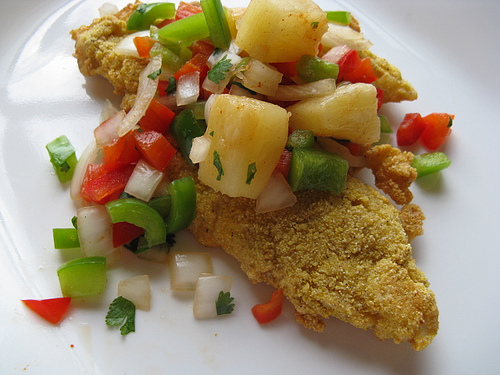 Cajun tilapia topped with pineapple and diced vegetables
