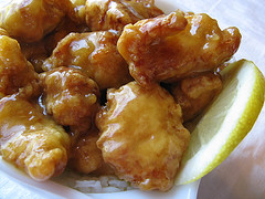 Close‑up of bite‑sized crispy lemon chicken coated in sweet and tangy lemon glaze