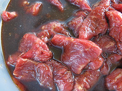 Raw flank steak in sauce 