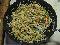 Chinese fried rice in a skillet with vegetables and egg