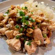 Close up view of Kung Pao chicken on a plate.