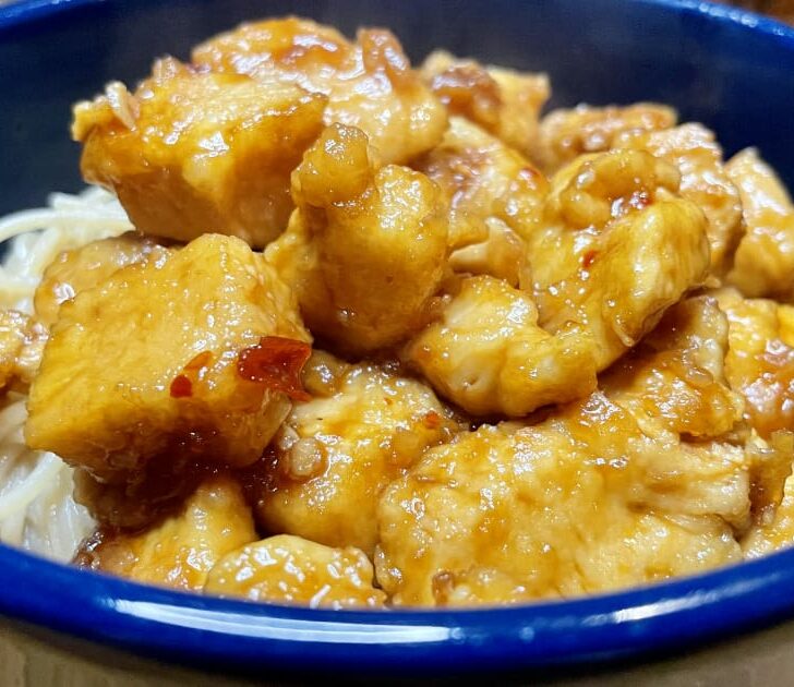 Prepared bourbon chicken in bowl.