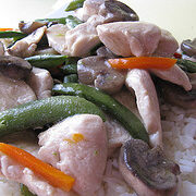 Close up of moo goo gai pan with carrots snow peas and mushrooms