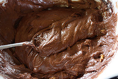 Mixing bowl of chocolate brownie batter being stirred
