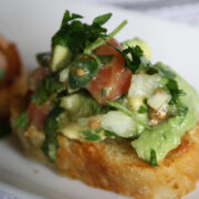 Guacamole bruschetta with diced tomato and avocado on bread