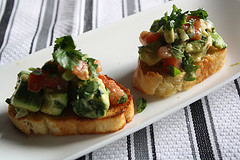 Guacamole bruschetta with diced tomato and avocado on bread