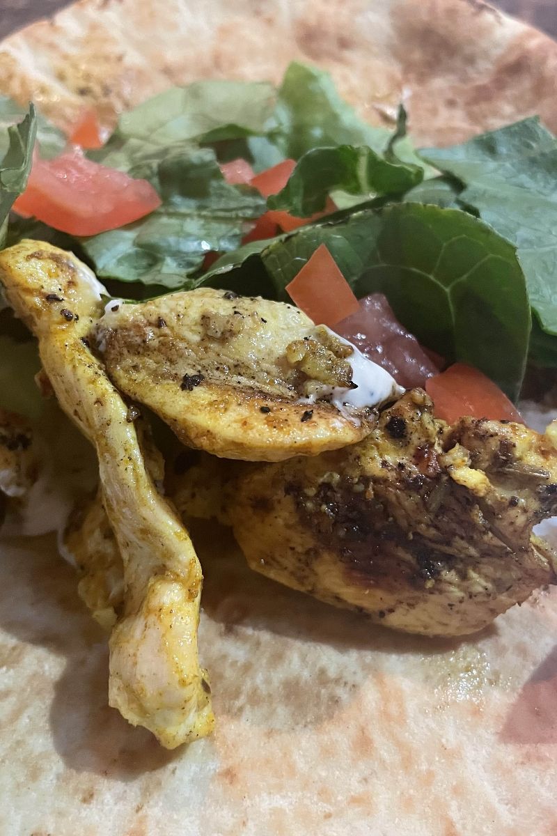 Prepared chicken shawarma recipe on pita bread.