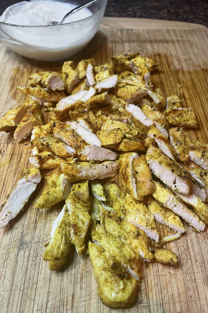 Prepared chicken shawarma on a cutting board.