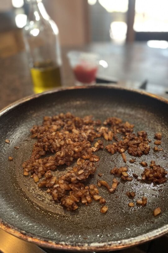 Onions and seasoning in skillet.