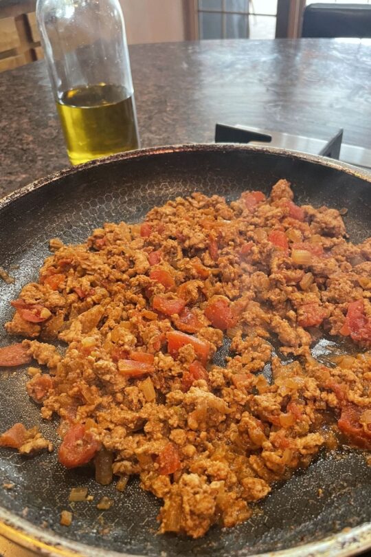 Ground turkey cooking in skillet.