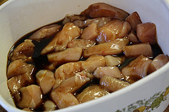 Chicken pieces marinating in garlic ginger sauce.