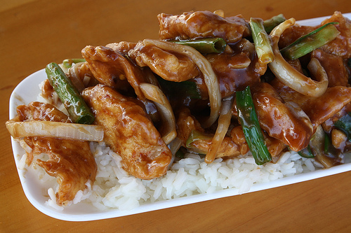 Mongolian chicken with crispy strips and onions over white rice