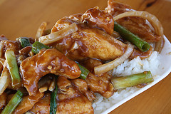 Mongolian chicken with crispy strips and onions over white rice