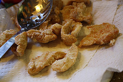 Crispy fried chicken strips draining on paper towel