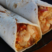 Shrimp burritos with melted cheese and rice inside