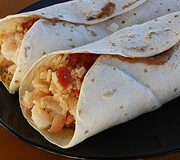 Shrimp burritos with melted cheese and rice inside