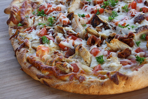 Chicken bacon ranch pizza on a wooden surface