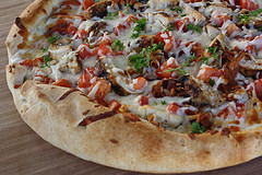 Chicken bacon ranch pizza on a wooden surface