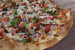 Chicken bacon ranch pizza on a wooden surface