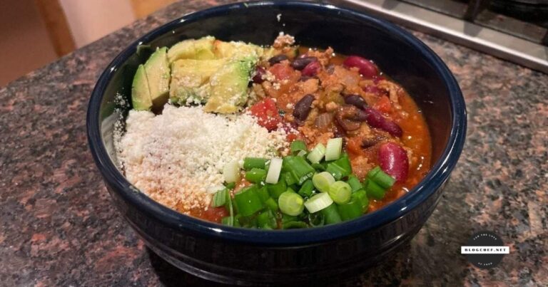 Prepared turkey chili with green onions, cotija cheese, and avocado.