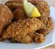 Fried fish fillets served with lemon