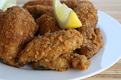 Fried fish fillets served with lemon.