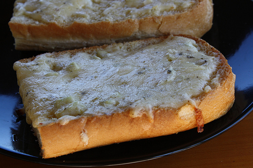 Homemade garlic bread with melted butter and herbs