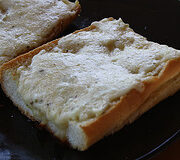 Homemade garlic bread with melted butter and herbs