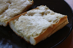 Homemade garlic bread with melted butter and herbs