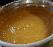 Pumpkin and spice mixture in a metal mixing bowl.