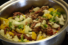 Pot of pumpkin chili showing fresh chopped vegetables before cooking