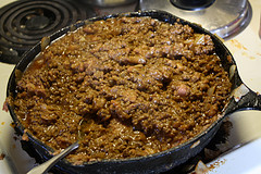 Skillet filled with cooked ground beef seasoned with spices