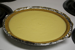 Unbaked key lime pie filling in a graham cracker crust