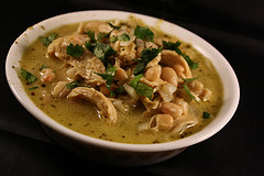 Bowl of white chicken chili topped with fresh cilantro