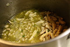 Pot of white chicken chili with shredded chicken and beans