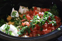 Fresh chili con queso ingredients with diced tomatoes and herbs