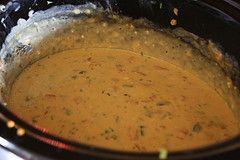 Pot of melted chili con queso with spices