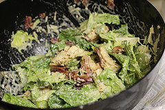 Chicken caesar salad mixture in a black skillet