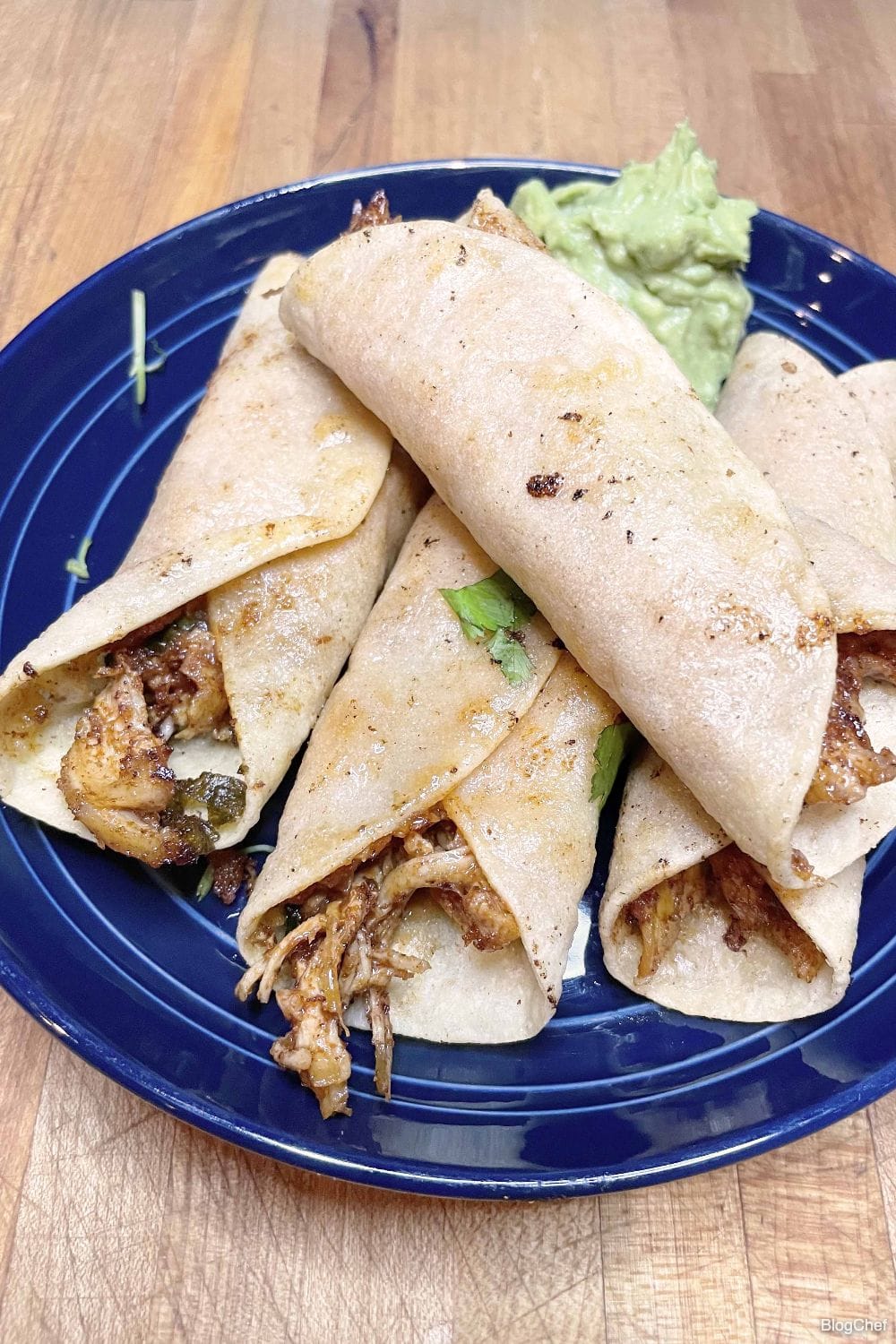 Prepared fried chicken taquitos with cilantro.