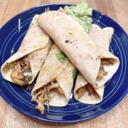 Prepared fried chicken taquitos with cilantro.