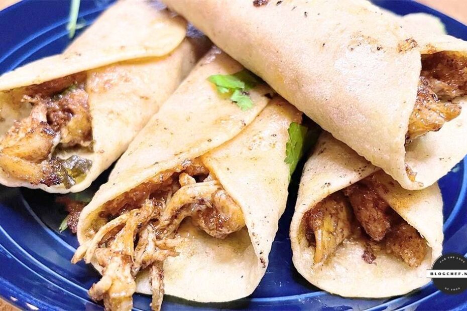 Prepared fried chicken taquitos with cilantro.