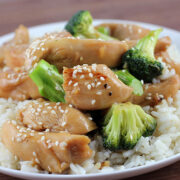 Chicken in garlic sauce served over white rice with broccoli and sesame seeds