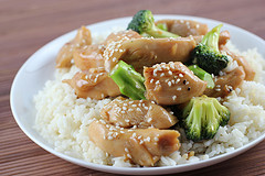 Chicken in garlic sauce served over white rice with broccoli and sesame seeds