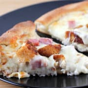 Prepared chicken cordon bleu pizza on plate.