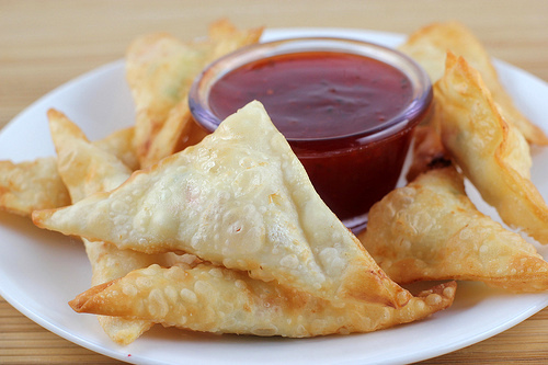 Cream cheese wontons with crab filling served with dipping sauce