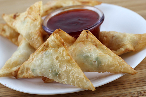 Cream cheese wontons with crab filling served with dipping sauce